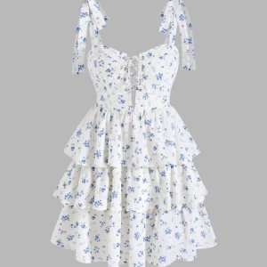 Blommig klänning - Vit klänning med blå blommor. Storlek XS, aldrig använd och lappen sitter kvar. Justerbara axelband 