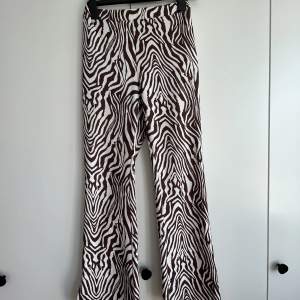 Perfect party pants. Stretchy zebra pattern in white and maroon (Taylor’s version). 