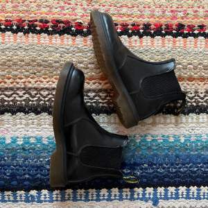 Chelsea boots från Dr Martens i svart läder. I använt skick, se slitningar på bild 2. Nypris runt 2000