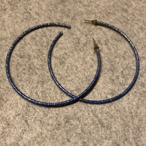 Glittriga hoops - Glittriga hoops, har aldrig använts men det har ändå skavts av lite på ett örhänge, men det är inget man tänker på. Okänt material. 
