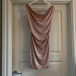 Mycket fin ny klänning köpt i exklusive butik i Grekland. Lite skimrande rosa glittrig med fint hjärta i riggningen på ryggen 