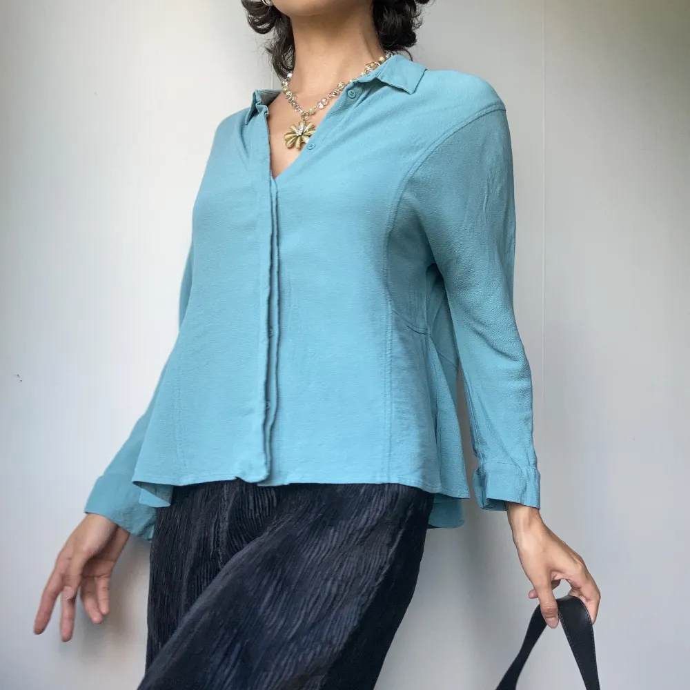 • BLUE SHIRT WITH SLIGHTLY FLARE BACK  • SIZE - M-L / EU 38-40/ Brand size 3 • BRAND -  Paul & Joe Sister • MATERIAL - 100% Viscose. Blusar.