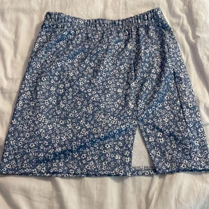 Blommig kortkjol  - En blommig kortkjol. I ett fint skick. 