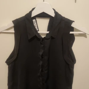 Proper v-skruen rygg sidentopp - Fin svart topp i siden. Vackra detaljer och vskurning bak.  Inköpt på vero moda eller gina tricot. 