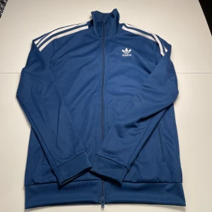 Adidas tracksuit wct beckenbaur - Säljer min adidas tracksuit då den inte kommer till användning. Att köpa bara byxorna eller bara tröjan är okej 