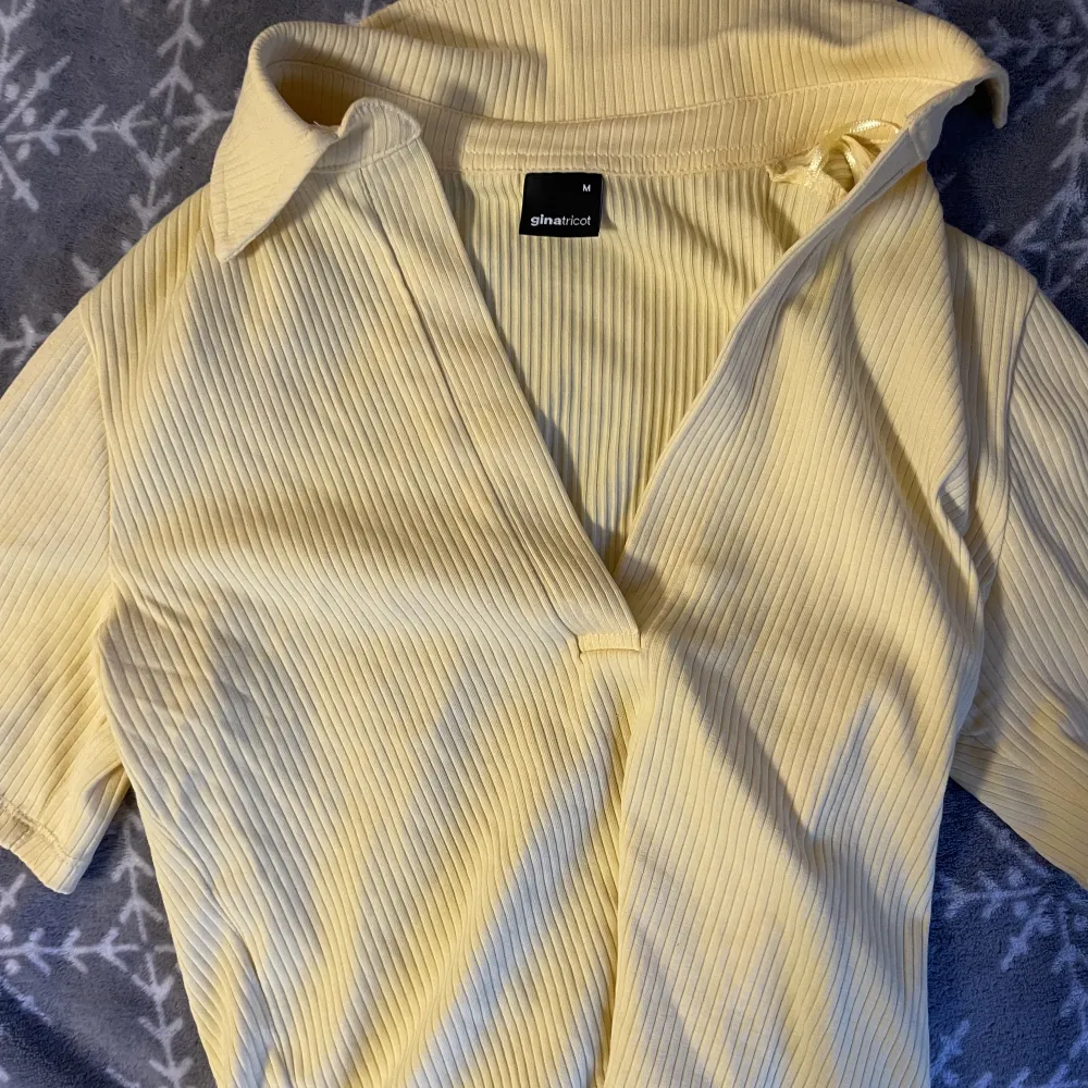 En ribbat gul t shirt från gina tricot i storlek M. T-shirts.
