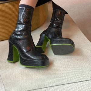Chunky platform boots 70s style - Funky vintage platå boots i ormskinns imitation och neongrön sula. Köpta i London. Väldigt bra skick! Står ingen storlek men skulle gissa 37. 