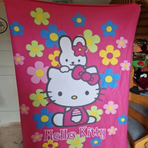 Hello Kitty fleecefilt - Jättesöt rosa filt i fleece med Hello Kitty. Ca 130x170 cm. Nästan helt oanvänd, och såklart nytvättad! 🩷  Obs! Katter finns i hemmet! Försöker såklart få bort så mycket hår som möjligt, men kan inte garantera att jag får bort allt!