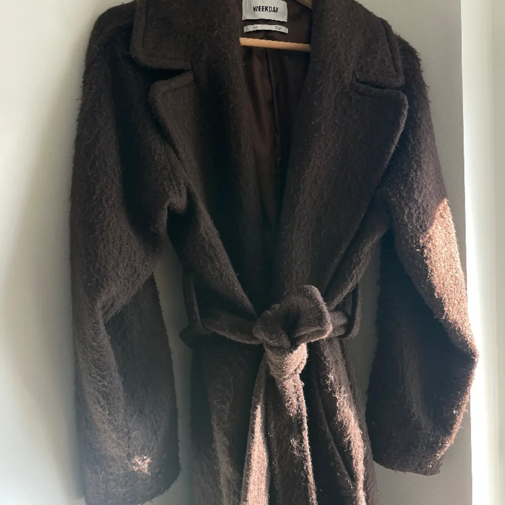 Kia Wool Blend Coat från Weekday. Brun Oversized lång kappa med skärp/bälte. Använd i ett år, dock ganska nopprig! Nypris 1400kr. Jackor.