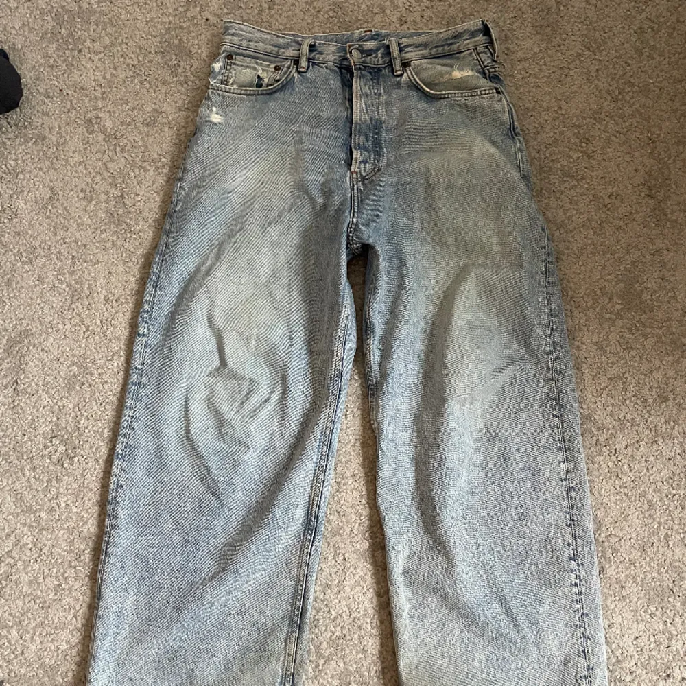 Ett par baggy jeans från acne studios Använt skick Sönder vid ben öppning Stl 29/30 Waist:40cm Length:103cm. Jeans & Byxor.