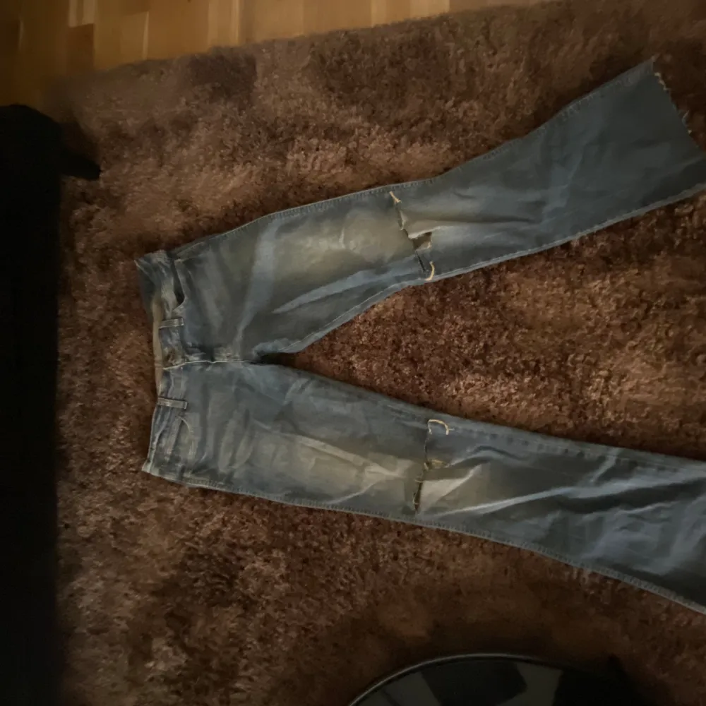Vintage jeans från Wrangler med hål i. Lågmidjade och utsvängda Innerbenslängd:81 cm (mätt från skrevet) Midjemått:39 cm . Jeans & Byxor.