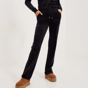 Svarta mjukisbyxor - Ett par svarta mjukisbyxor i ett mjukt och bekvämt material. Byxorna har en normal passform och är perfekta för avslappnade tillfällen. Juicy Couture, helt ok skick, de gröna är bättre därav de billiga priset