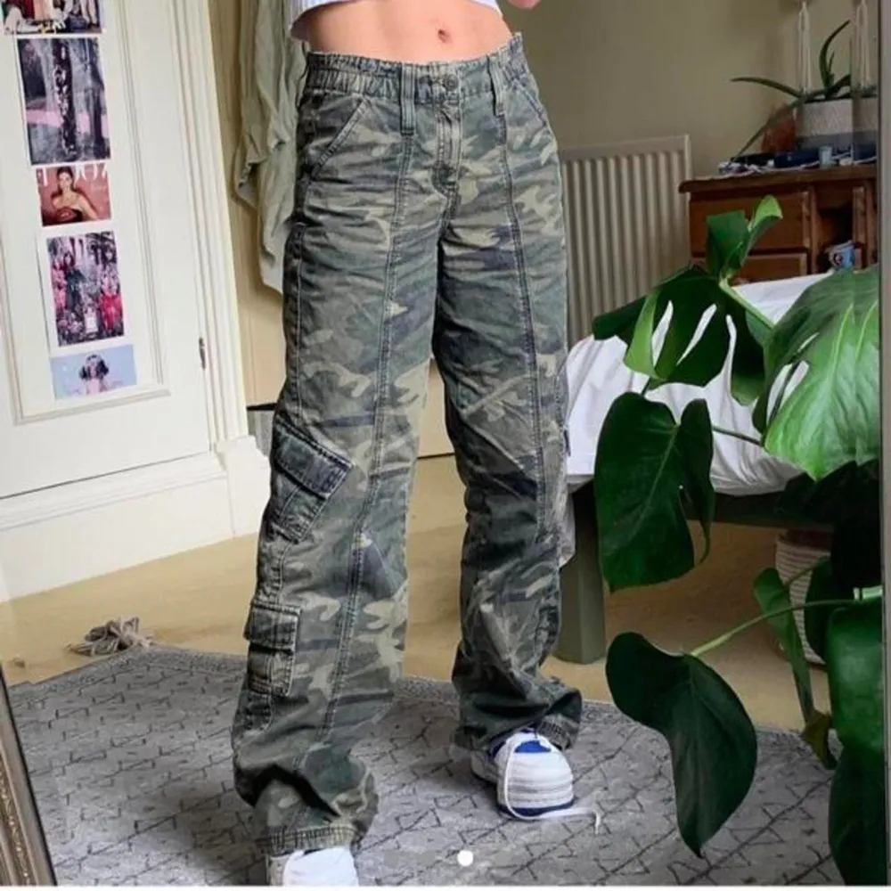 Pösiga Y2K camouflage cargo byxor från Urban outfitters. Stretchig midja och i bra kvalite. Endast använd någon gång då dem är långa på mig som är 157cm. Bra kvalite på materialet och inköpta för 800kr.. Farkut & Housut.