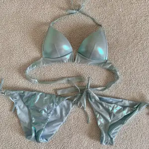 Otroligt snygg bikini från Calzedonia i holografisk blå färg. Mermaid effekt 🧜‍♀️ Använd en gång på spa. I nyskick, utan anmärkningar. Storlek 75B i överdel och S och M i bikiniunderdel. Ordinariepris över 1000kr.