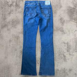 Snygga lågmidjade true religion bootcut jeans med midja 36 cm och innerben 75cm. i modell ”mid rise” men jag skulle säga att dem är lågmidjade.