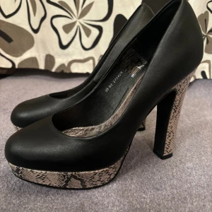 Högklackar med ormmönster - Klackarna är använda men i sparsamt skick