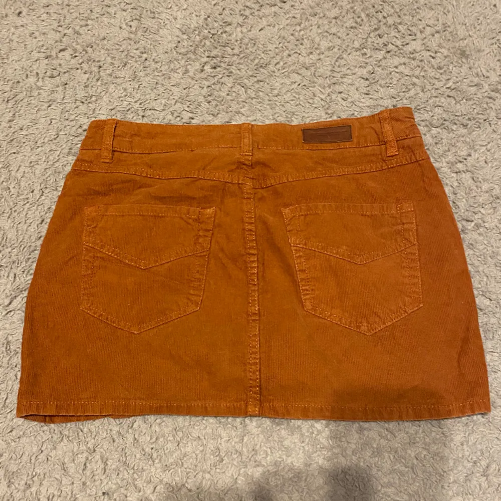 orange kort kjol från h&m! står strl. 38 men passar defintivt bättre 36. Kjolar.