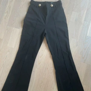 Fina byxor från river island i petite  - Smickrande figursydda byxor i lyxigt material och guld knappar. Petite modell. Märkta storlek 10 men jag tycker dom är lite små i storlek. 