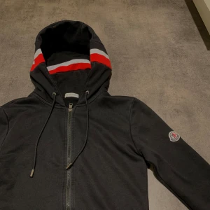 Moncler Zip - En moncler Zip jag vill sälja pågrund av att jag behöver pengarna. Den är i helt okej skick o har inga fläckar eller hål. Den är i storlek M. Jag säljer den för 700 men pris kan diskuteras. För mer bilder eller frågor skicka i chatten