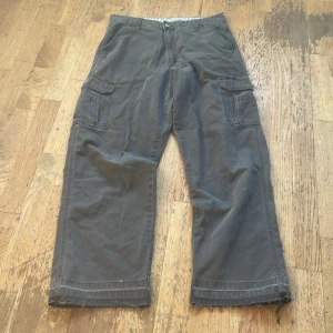Cargo Byxor  - Riktigt feta Vintage Wrangler cargos i en washed brun färg, uppsprättad längst ned, ingen storlekslapp men passar som 32/32 på mig. Pris går alltid att diskutera vid snabbaffär🤝