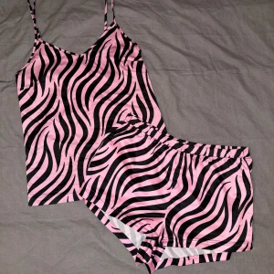 Pyjamas set - Rosa svart zebra mönstrad pyjamas set i satin, storlek S. Linnet är lite mer använt och slitet men fortfarande fint, shortsen är nästan aldrig använda då de var för små för mig. 