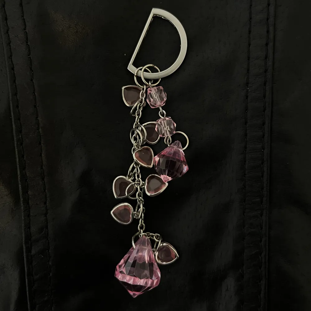 Ett rosa smycke som passar jättebra att sätta på väskan! . Accessoarer.