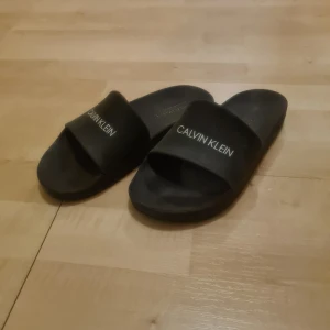 Badtofflor - Säljer ett par badtofflor från Calvin Klein i storlek 38, skulle säga att de är lite små i storleken så mer åt 37/37,5. Säljer då de är försmå för mig, har använts några gånger. Köparen står för frakten💕 Skriv vid frågor💕