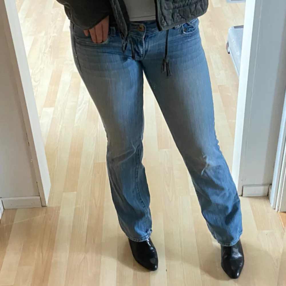 Extremt fina low waist jeans med en urtvättad blå färg. Jag är 1,69 för jämförelse och har klackar på bilden, de sitter perfekt vid mina fötter. . Jeans & Byxor.