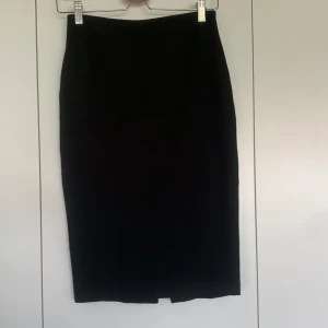 Svart pennkjol  - Fin mjuk svart pennkjol med slits bak och dragkedja.  