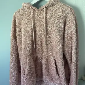 Supermysig rosa fluffig hoodie. Köpt på H&M. Storlek L men skulle säga att den motsvarar en M. Jättemjuk och varm.