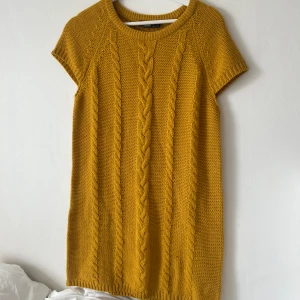 Stickad klänning - Stickad klänning köpt på röda korset. märket ESmara storlek medium men sitter fint på mig som brukar ha xs. Sitter löst men jättefint så funkar för olika storlekar beroende på hur man vill den ska sitta!!Senapsgul blandat med ljusbrun typ 