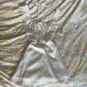 Klänning  - Sötaste klänningen!! Använd 1 gång 🌷💞 i nyskick!! Den har dragkedja i sidan och knytning bak över ryggen samt på bröstet