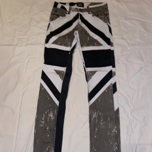 Mönstrade Jeans - Ascoola jeans med Englands flagg-tryck. Använt ett fåtal gånger (2-3 gånger) Katt finns i hemmet.  Köpta på EMP. W27 / L32 Möts inte upp & köparen betalar frakten.