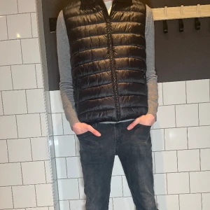 Dunväst - Riktigt stilren dunväst från märke studio total, 10/10 skick, storlek M men passar även L. Modellen är 189 och väger 68 kg. Nypris cirka 400 kr, vårt pris 199 kr. Hör av dig vid minsta fråga!