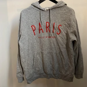Hoodie - Grå huvtröja från H&M med tryck. Säljs då den ej används längre!