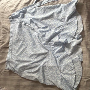 Blommig kjol - En fin ljusblå blommig kjol i bra skick, endast använd några gånger. Storlek XL