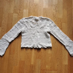 Stickad tröja  - Jättefin vit mönsterstickad tröja med volangärm. Från monki. I fint skick (endast använd en gång)