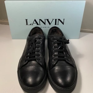 Lanvin Cap Toe Sneaker Svart - Hej, säljer ett par populära lanvin Cap Toe Sneaker i svart läder. Endast använda 1 gång då de va för stora. Utmärkt skick. Box medkommer vid köp. Nypris 4600kr. Size 9 vilket motsvarar 43/44. Pris kan diskuteras. Hör av dig i Dm vid intresse.