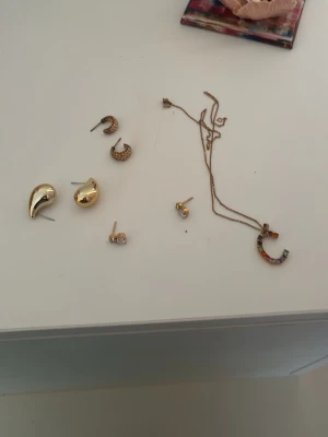 Caroline Svedbom smycken  - Säljer ett set med flera olika örhängen i både guld- och silverfärg. Setet innehåller droppformade, runda och halvmåneformade örhängen samt några med små stenar. Perfekt för dig som gillar att mixa och matcha olika stilar. Säljer var för sig så meddela vilket smycke så skriver jag pris ❣️
