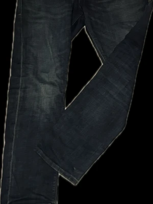 Jack&jones tapered Mike intelligence/ Tim original  - Snygga mörkblå jeans med tapered Mike i passform och klassisk femficksdesign. Jeansen har subtila slitningar och kontrastsömmar som ger en cool look. Perfekta till en avslappnad stil och tillverkade i denim för en bekväm känsla. 