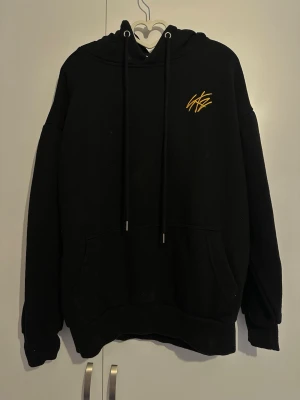 Official Stray Kids Unlock: go live in life fleece jacket - Svart hoodie med huva och dragsnören, samt känguruficka framtill. På bröstet finns gul brodyr med texten 'UNLOCK: GO LIVE IN LIFE' och 'STRAY KIDS'. Materialet är mjukt och skönt, perfekt för dig som gillar streetwear och K-pop. Köpt från Korea tillbaks i 2020. Använts ca 2-4 gånger. Passar S/M/L, är själv S så den är lite oversize. Köpt för 1200 i nypris men sänker, kan förhandla priset, men har inga pengar för mina cancer mediciner så måste sälja den.
