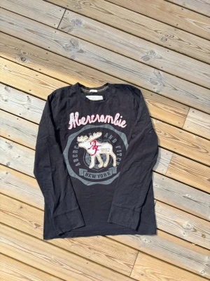 Vintage Abercrombie & Fitch long sleeve - Säljer denna Vintage Abercrombie & Fitch long sleeve i mycket bra skick, finns en defekter se bild 4. Storlekslappen är borta men sitter som en L/M. Hör av er vid frågor eller minsta fundering 🙌  Se mått nedan:  Längd: 73 cm  Bred: 51,5 cm  Ärm: 67 cm