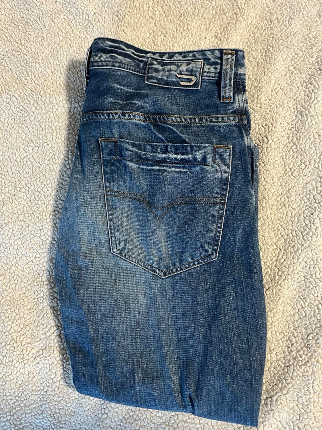 Blå raka jeans med slitningar