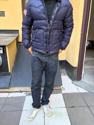 Ralph Lauren Dunjacka - Extremt sällsynt dunjacka från ralph lauren denim and supply! Flaggan har gått sömder i mitten, men tycker själv det ser lite coolt ut. Annars är den i bra skick! Modellen är 180cm och väger 70kgExtremt sällsynt dunjacka från ralph lauren denim and supply! Flaggan har gått sömder i mitten, men tycker själv det ser lite coolt ut. Annars är den i bra skick! Modellen är 180cm och väger 70kg