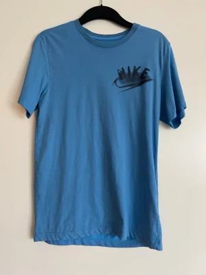 T-shirt nike - En väldigt skön och mysig T-shirt från Nike!   Längd: ca 70 cm  Inköpt på herr men går att använda även som dam, som jag har gjort. Det är 57% bomull i materialet. 