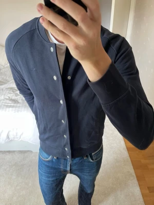 HELT NY mörkblå cardigan från J.Lindberg - Säljer en SPRILLANS NY cardigan från J.Lindberg i storleken M med taggsen kvar! 😁✌🏼        ——————————————————————————                                                                          📐| Storlek: M                                                             👖| Märke: J.Lindberg                                            🔎| Skick: DEN ÄR NY!                                                     ✍🏻| Skriv om du har några frågor