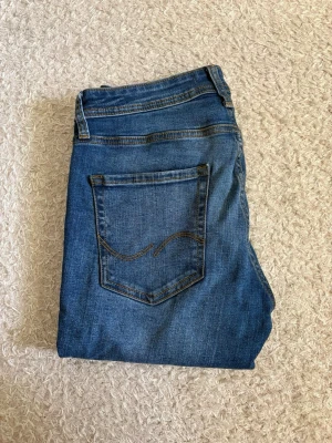 Jack & Jones Slim Straight Tim Jeans - Blå jeans från Jack & Jones, modell Slim Straight Tim. Använda en del och i bra skick utan hål.  Klassisk tvätt och slim straight-passform som passar till det mesta. Säljs då de blivit för små. 📦 Snabb leverans! 💬 Hör gärna av dig vid frågor eller om du vill ha fler bilder eller mått!