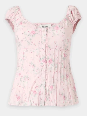 Ljusrosa blommig topp  - Supersöt ljusrosa topp från Hollister med blommigt mönster i rosa och grönt. Toppen har korta puffärmar, knappar framtill och lätt rynkade detaljer. Använd ungefär 1-2 gånger och har inga tecken på användning🙌🏼 Nypris: 449kr