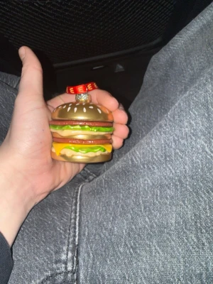 Ingen väst på bilderna - Bilderna visar en julgransprydnad formad som en hamburgare, inte en väst. Ingen information om väst finns att beskriva.