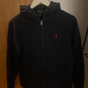 Polo hoodie - En klassisk mörkblå Polo Ralph lauren zip hoodie som är i använt skicka men fortfarande absolut väldigt användbar. Pris kan diskuteras vid snabb affär 🙌